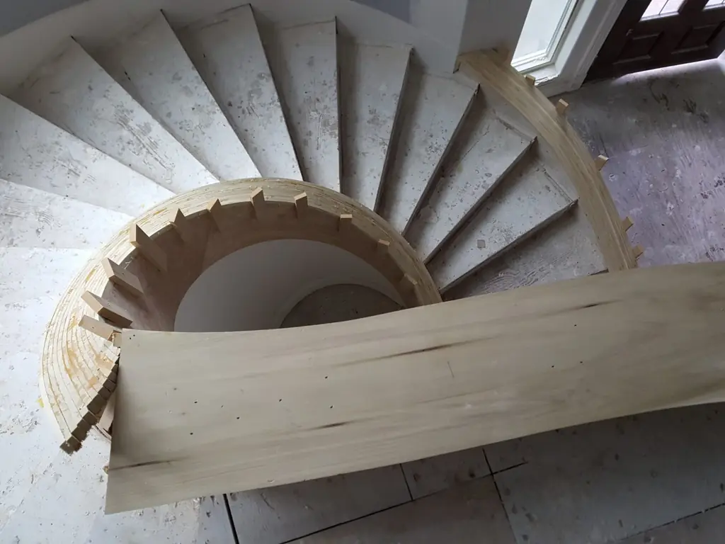 A curved stair stringer being laminated on site during construction of an Envision home